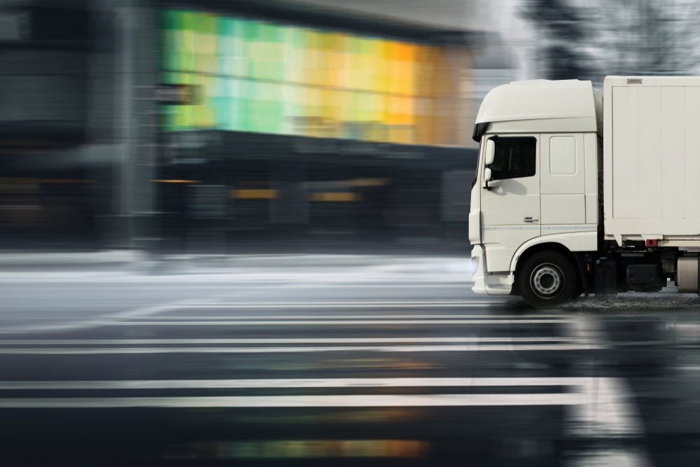 Truck,Drives,On,A,Wet,Street,Through,A,City
