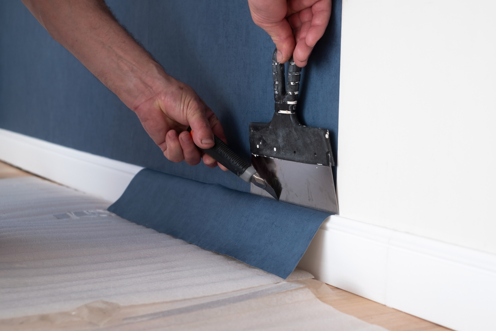 Man,Cutting,Wallpaper.,Maintenance,Repair,Works,Renovation,In,The,Flat.